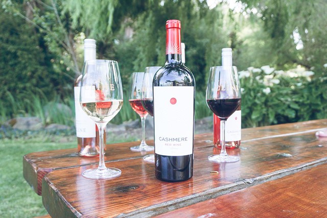 Several bottles of Cashmere Wine on a picnic table in a California Winery