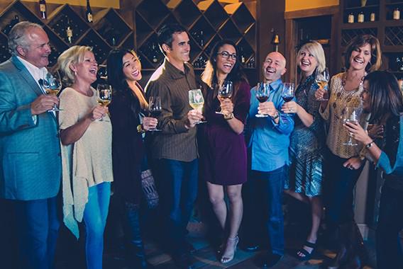 Group of couples tasting wine and laughing