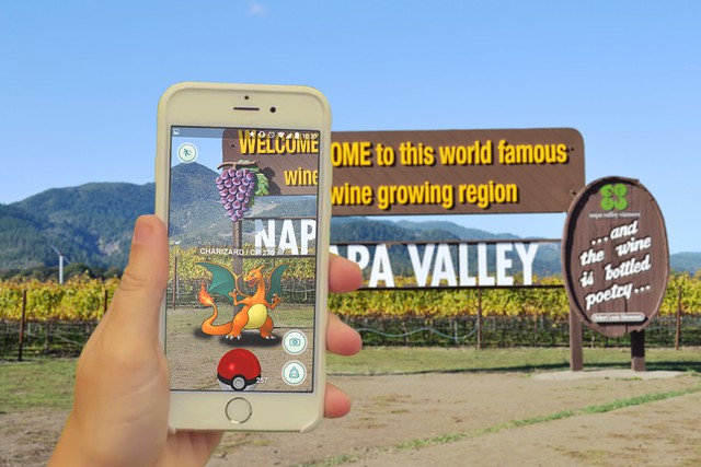 Someone playing Pokemon GO in front of the Welcome to Napa Valley sign
