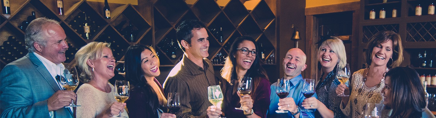 Guests on a Grapeline wine tour raise a glass of wine to make a toast at Adelaida Vineyards and Winery. This winery along with others in the Paso Robles region have a focus on sustainable agriculture, organic farming, and long-term wellbeing for both visitors and employees.